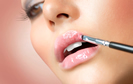 Woman applying lip gloss